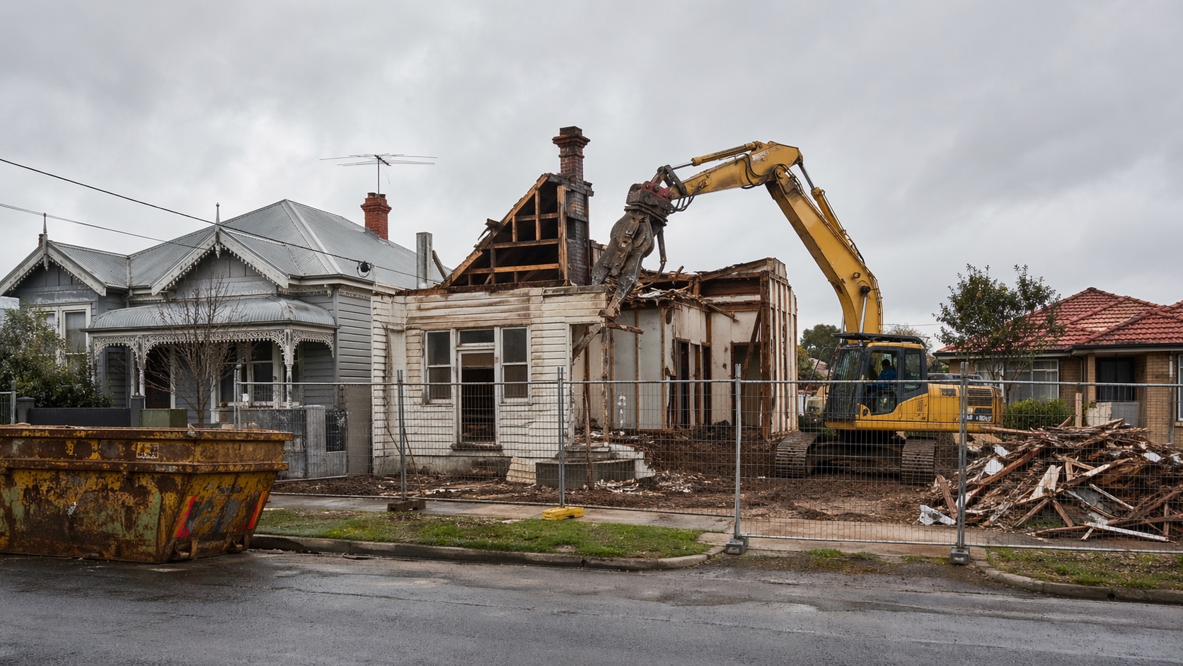Australian house demolition site with excavator and safety fencing