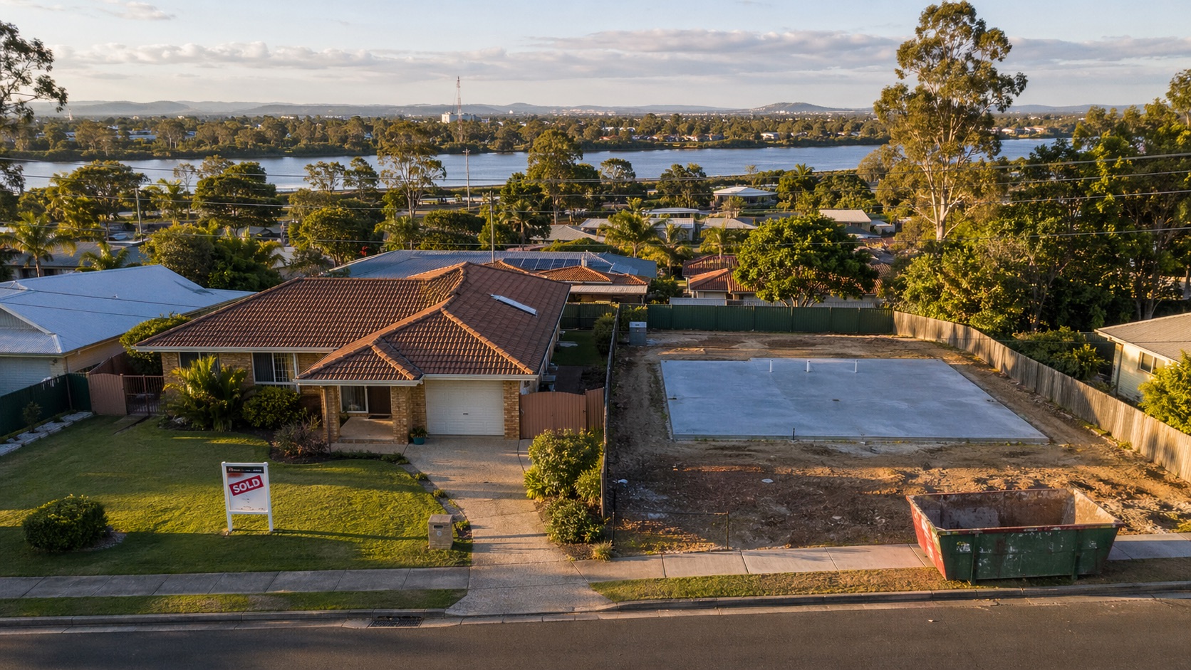Eagleby house with Sold sign next to a freshly poured concrete slab